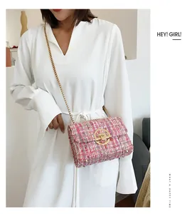 Detail of pink tweed crossbody bag featuring gold chain strap and round metallic lock