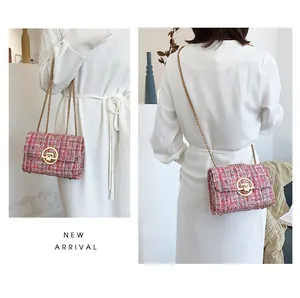 Detail view of multi-color tweed crossbody bag with gold chain strap and metal clasp