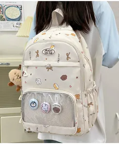 Side view of white cartoon school bag with transparent display pocket and plush charms
