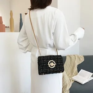 Elegant black tweed chain crossbody bag with gold hardware shown in a minimalist room