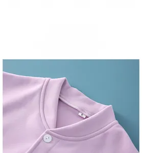 Detail of purple fleece shoulder warmer featuring stand collar and button closure