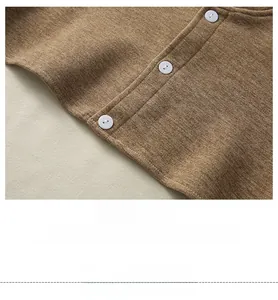 Detailed close-up of brown knit fabric with precise four-needle six-thread stitching