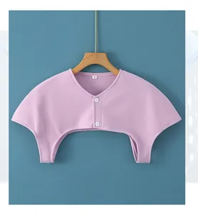 Detailed view of light purple knit shoulder warmer with double-breasted white buttons