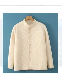 Close-up of beige quilted thermal shoulder wrap with buttons and stand collar texture