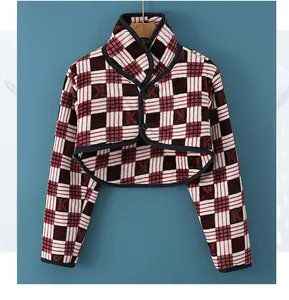 Detail showing checkered plaid pattern with letter K texture and double-button closure