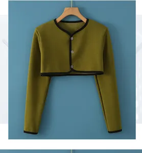 Detail view of olive green thermal shoulder wrap with black trim and three buttons