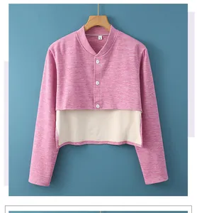 Detail view of pink dralon shoulder warmer with three white buttons and thermal lining