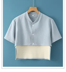 Close-up of light blue shoulder warmer vest with white buttons and soft stand collar detail