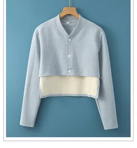 Detailed view of women's thermal shoulder wrap with layered hem and white buttons