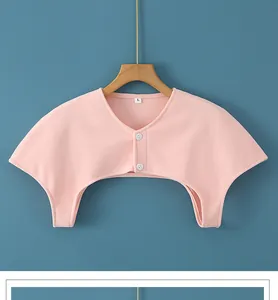 Detail view of pink thermal shoulder warmer with buttons and soft knit texture