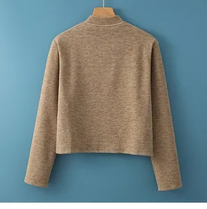 Close-up of oatmeal-colored thermal shoulder wrap with soft textured knit fabric