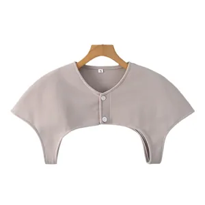 Knitted shoulder warmer in light beige with double button closure for neck protection