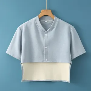 Light blue shoulder warmer vest with ribbed collar and three white buttons for elderly women