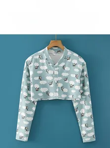 Detail of light blue shoulder warmer wrap with cute bear and cloud patterns in cotton