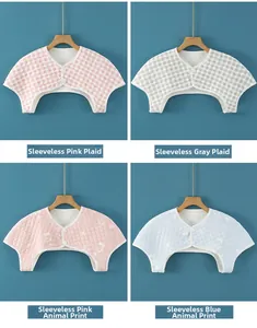Detailed view of four patterns of quilted cotton shoulder protectors on hangers