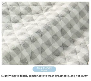 Close-up of grey plaid quilted fabric showing breathable and skin-friendly texture