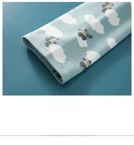 Close-up of baby shoulder wrap cuff featuring cartoon prints and rib-knit finish