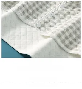 Close-up of gingham fabric shoulder warmer with four-needle six-thread quilting detail