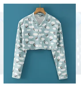 Detail showing soft blue knit shoulder wrap with clouds and cartoon cloud patterns