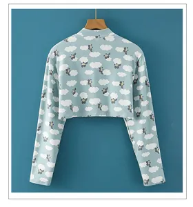 Detail of light blue cropped knit wrap featuring cloud pattern and soft knitted texture