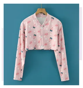 Detail of pink sleep shrug with cute cupcake prints and buttons on aqua background