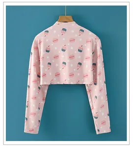 Detail of soft pink shoulder wrap with sweet cupcake and macaron prints on wood hanger