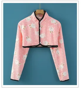 Close-up of pink fleece shoulder warmer featuring cute rabbit patterns and snap buttons