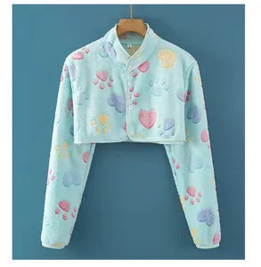 Close-up of soft flannel shoulder wrap featuring colorful heart patterns and buttons