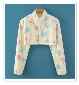 Close-up of soft yellow flannel shoulder warmer with heart and paw prints and buttons