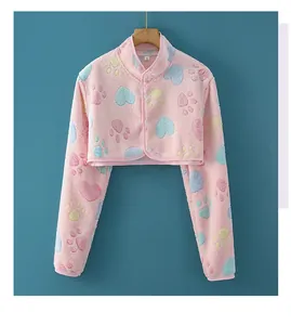 Close-up of pink flannel shoulder warmer with soft heart patterns and button detail