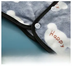 Close-up of thick grey flannel shoulder protector with teddy bear embroidery and fine stitching
