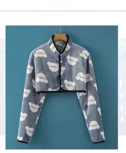 Detail of grey flannel shoulder warmer with cute bear pattern and button closure