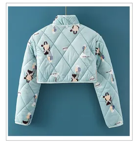 Detail of light blue quilted shoulder warmer with cartoon cat prints and button collar