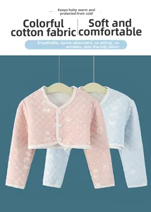 Détail de la veste thermique matelassée pour bébé en coton coloré avec motifs de chiots doux