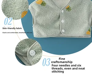 Detail of baby thermal shoulder vest showing soft fleece texture and pineapple embroidery
