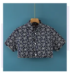 Close-up of quilted floral shoulder protector wrap with traditional Chinese stand-up collar