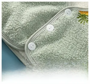 Close-up of baby warm shoulder vest with soft plush fabric, lamb wool lining and buttons