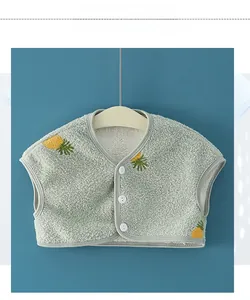 Detail of fleece kid vest featuring cute pineapple embroidery and white buttons