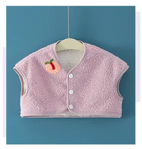 Detail of pink fleece vest showing plush texture, peach embroidery, and white buttons
