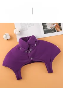 Detail of purple padded neck and shoulder warmer with button closure on orange background