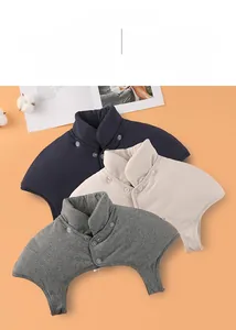 Detailed close-up of thick shoulder protector shawl with high collar and buttons