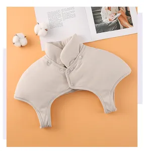 Detail view of the thick beige thermal shoulder protector with transparent buttons