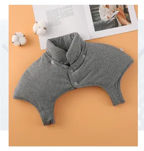 Close-up of gray knitted thermal shoulder protector with high neck and button detail
