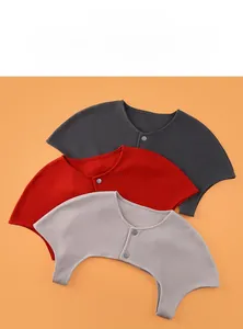 Close-up of three warm shoulder wraps in thermal fabric with button closure and breathable texture