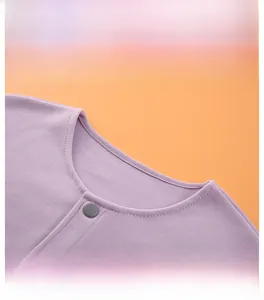 Detail of round neckline with snap button on soft purple thermal velvet shoulder wrap