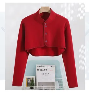 Detail of dark red fleece bolero jacket with stand collar and buttons on a hanger