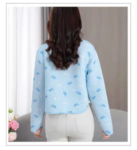 Rear view of light blue quilted shoulder protector with fish print for neck warmth