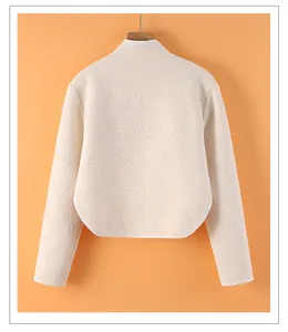 Detail showing back view of beige thermal shoulder protector with embossed bear pattern