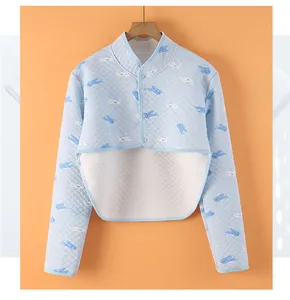 Detail of light blue quilted shoulder protector with cute cartoon shark prints and buttons