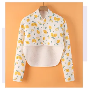 Detailed close-up of quilted cotton shoulder warmer with lemon patterns and button closure